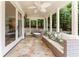 The spacious sunroom with flagstone floors and comfortable furniture offers a tranquil view of the backyard at 70 Finch Forest Trl, Atlanta, GA 30327