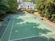 Overhead shot of the backyard tennis court surrounded by lush mature trees and landscaping at 70 Finch Forest Trl, Atlanta, GA 30327