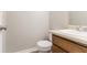 A classic bathroom features a toilet, wooden vanity with sink, and shower-tub combination at 10 Briarcliff Pl, Stockbridge, GA 30281