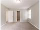 An open-concept bedroom with neutral walls and plush carpeting, leads to other rooms in the home at 10 Briarcliff Pl, Stockbridge, GA 30281