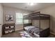 Modern bedroom featuring a bunk bed, neutral decor, and a playful area rug at 10 Briarcliff Pl, Stockbridge, GA 30281