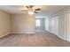 Spacious bedroom with neutral walls, carpet flooring, ceiling fan, and double door closets at 10 Briarcliff Pl, Stockbridge, GA 30281
