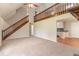 Spacious living room with a staircase, fireplace, and open access to the kitchen area at 10 Briarcliff Pl, Stockbridge, GA 30281