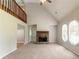 Bright living room featuring a stone fireplace, vaulted ceilings, and natural lighting at 10 Briarcliff Pl, Stockbridge, GA 30281