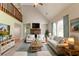 Bright living room featuring vaulted ceilings, a stone fireplace, and plush neutral-toned furnishings at 10 Briarcliff Pl, Stockbridge, GA 30281