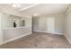 Cozy living room with neutral carpet and paint, mirror accent, and ample natural light at 10 Briarcliff Pl, Stockbridge, GA 30281