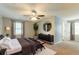 Serene main bedroom with neutral tones, a ceiling fan, and a decorative area rug at 10 Briarcliff Pl, Stockbridge, GA 30281