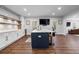 Kitchen with island and modern appliances and cabinets with bar and tv at 120 Nezhat Pl, Sandy Springs, GA 30350