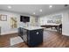 Bright and open kitchen island, with bar and adjacent living room at 120 Nezhat Pl, Sandy Springs, GA 30350