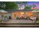 Relaxing back deck with comfortable seating, outdoor lighting, and stylish black and white striped rug at 3357 Pretty Branch Se Dr, Smyrna, GA 30080