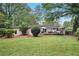 Spacious backyard showcasing a deck, lush lawn, mature trees, and privacy landscaping at 3357 Pretty Branch Se Dr, Smyrna, GA 30080