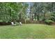 Expansive backyard with a well-kept lawn, wooden fence, and comfortable lounge chairs at 3357 Pretty Branch Se Dr, Smyrna, GA 30080