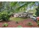 Extensive backyard featuring a deck, manicured lawn, mature trees, and garden beds at 3357 Pretty Branch Se Dr, Smyrna, GA 30080