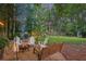 Secluded backyard oasis with a fire pit, swing bench, and lush greenery, perfect for relaxation at 3357 Pretty Branch Se Dr, Smyrna, GA 30080