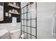 Contemporary bathroom with sleek black and white design, featuring a glass-enclosed shower at 3357 Pretty Branch Se Dr, Smyrna, GA 30080