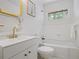 Bright bathroom featuring a white vanity, gold fixtures, and a bathtub with tiled walls at 3357 Pretty Branch Se Dr, Smyrna, GA 30080