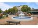 Scenic community fountain surrounded by well-maintained landscaping, benches, and charming buildings at 3357 Pretty Branch Se Dr, Smyrna, GA 30080