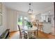 Cozy dining area with white wainscoting, modern lighting, and French doors leading to the backyard at 3357 Pretty Branch Se Dr, Smyrna, GA 30080