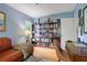 Comfortable living room featuring a leather couch, bookshelf, and a cozy atmosphere at 3357 Pretty Branch Se Dr, Smyrna, GA 30080