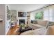 Cozy living room with a fireplace, built-in shelves, a large window, and comfortable seating at 3357 Pretty Branch Se Dr, Smyrna, GA 30080