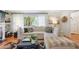 Bright living room featuring hardwood floors, a sectional sofa, and a large window with natural light at 3357 Pretty Branch Se Dr, Smyrna, GA 30080