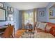 Charming living room with a cozy leather sofa, hardwood floors, and ample natural light at 3357 Pretty Branch Se Dr, Smyrna, GA 30080