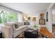 Relaxing living room with a large window offering a peaceful view, neutral decor, and hardwood floors at 3357 Pretty Branch Se Dr, Smyrna, GA 30080