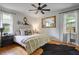 Bright bedroom with hardwood floors, a ceiling fan, and well-lit windows at 3357 Pretty Branch Se Dr, Smyrna, GA 30080