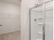 Bathroom featuring walk-in shower and attached walk-in closet at 580 Silver Moon Dr, Loganville, GA 30052