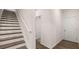 Hallway featuring stairs, luxury vinyl plank flooring, and access to storage at 580 Silver Moon Dr, Loganville, GA 30052