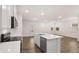 Open-concept kitchen with an island and modern appliances and fixtures at 580 Silver Moon Dr, Loganville, GA 30052