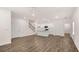 Open-concept living space with hardwood floors, kitchen, and staircase at 580 Silver Moon Dr, Loganville, GA 30052