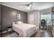 Bedroom featuring a gray accent wall, ceiling fan, and hardwood floors at 955 Juniper Ne St # 3331, Atlanta, GA 30309