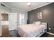 Bedroom featuring a gray accent wall, hardwood floors and adjacent bathroom at 955 Juniper Ne St # 3331, Atlanta, GA 30309