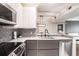 Modern kitchen with stainless steel appliances, gray cabinets, and mosaic backsplash at 955 Juniper Ne St # 3331, Atlanta, GA 30309