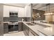 Modern kitchen boasts stainless steel appliances, gray cabinets and countertops, and stylish backsplash at 955 Juniper Ne St # 3331, Atlanta, GA 30309