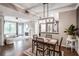 Open-concept living room featuring dark wood floors, fireplace, and dining area under modern lighting at 955 Juniper Ne St # 3331, Atlanta, GA 30309