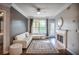 Bright living room with fireplace, a white couch, and a door leading to an outdoor balcony space at 955 Juniper Ne St # 3331, Atlanta, GA 30309