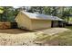 View of the house's backyard showing a large concrete patio and wooden privacy fence at 115 Bond Dr, Ellenwood, GA 30294