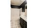 Bathroom featuring granite counters, single vanity sink, tiled flooring, and tub with shower at 115 Bond Dr, Ellenwood, GA 30294