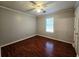 Cozy bedroom featuring a window and hardwood flooring at 115 Bond Dr, Ellenwood, GA 30294