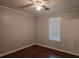 This bedroom features neutral walls, modern ceiling fan, and wood flooring at 115 Bond Dr, Ellenwood, GA 30294