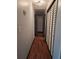 Hallway with neutral walls, hardwood floors, and closet space at 115 Bond Dr, Ellenwood, GA 30294