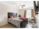 Bedroom features laminate wood flooring, ceiling fan, window, and TV at 5357 Beaver Br, Norcross, GA 30071