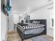 Bedroom with laminate wood flooring, window, TV, and bed at 5357 Beaver Br, Norcross, GA 30071