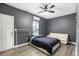 This is a bedroom with dark gray walls, a ceiling fan, and walk in closet at 5357 Beaver Br, Norcross, GA 30071