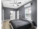 This is a bedroom with dark gray walls, a ceiling fan, and walk in closet at 5357 Beaver Br, Norcross, GA 30071