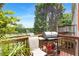 Outdoor deck area with grill, chair and view of surrounding trees at 5357 Beaver Br, Norcross, GA 30071