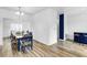 Dining area with a wooden table, blue chairs, and modern wood floors, creating a cozy space at 5357 Beaver Br, Norcross, GA 30071