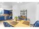 Eat-in kitchen with blue cabinetry, stainless appliances, and dining area with table at 5357 Beaver Br, Norcross, GA 30071